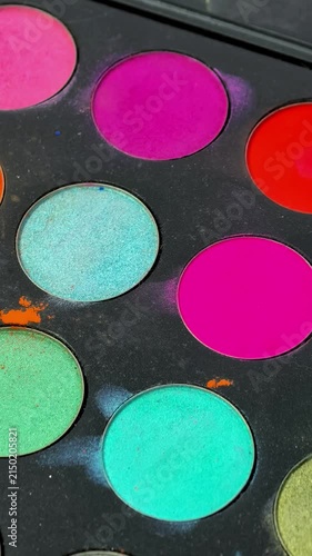 Colorful professional makeup palette with bright cosmetic shades in close up, beauty products, creative makeup, color selection, salon tools.