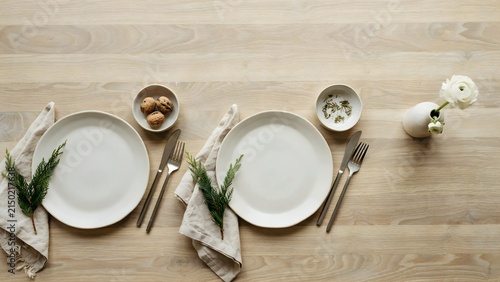 Elegant Dining Table Setup with Simple Plates and Natural Decor