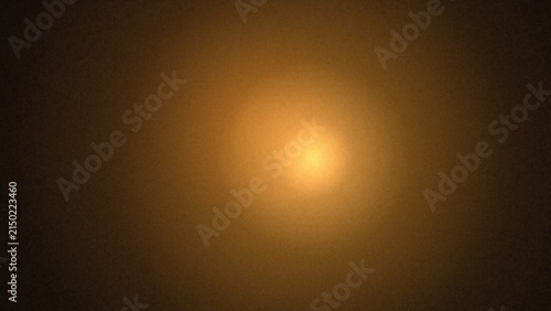 Soft glowing golden orb radiating light in a dark hazy atmosphere