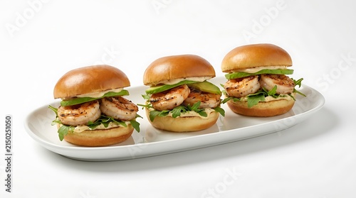 Three delicious mini chicken sliders on a serving platter. grilled shrimp sliders