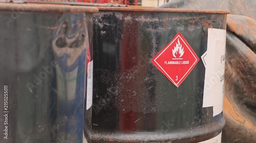 Flammable liquid warning sign on the chemical metal barrel. Industrial safety sign on the object, close-up with selective focus.