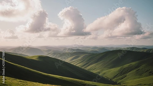 Clouds drifting over lush green mountain ridges in the morning