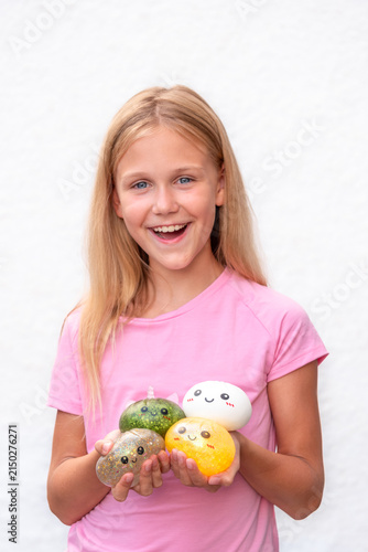 Happy Smiling Girl Holding Four Colorful Dumpling Toys, Sensory Squishy Toy Collection Isolated on White Background with copy space

