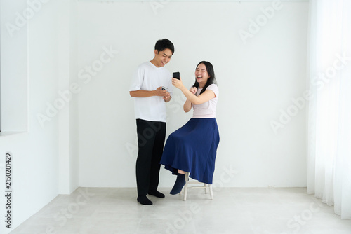 Japanese Man and Woman Using Smartphones Together