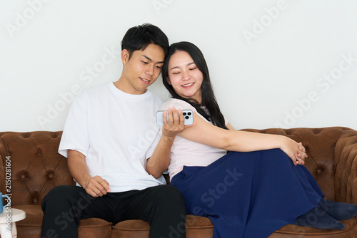 Japanese Man and Woman Using Smartphones Together