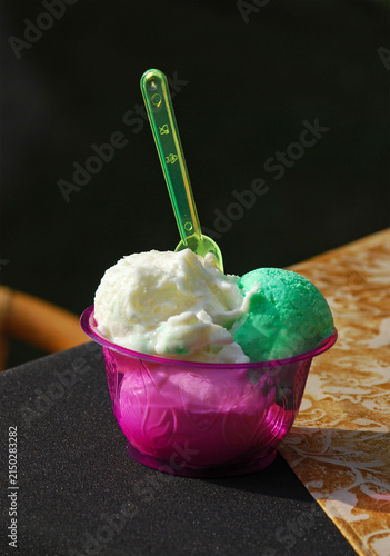 ice-cream cup with plastic spoon on table