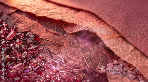 Macro red felt textile with dried leaf, mesh fabric and sparkling decorative beads