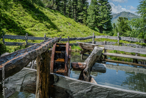 Waterwheel with pond at Graukogel in Bad Gastein, Austria