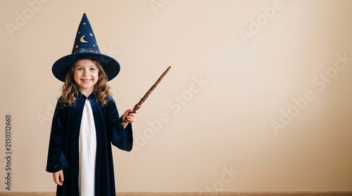 Young girl dressed as a wizard holding a magic wand