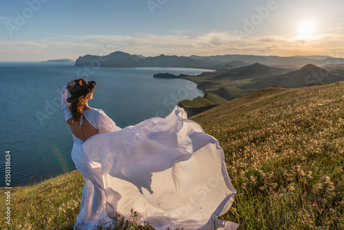 Konstfotografi Woman hat dress, silhouette of a woman in a flowing white dress and hat looking