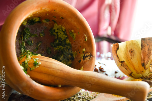 Cuadro en lienzo Grinding fresh herbs in a mortar and pestle