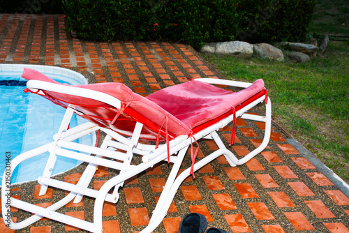 Lounger Beside Swimming Pool on a Sunny Day