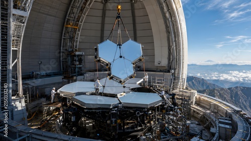 Segmented telescope mirror inside observatory dome