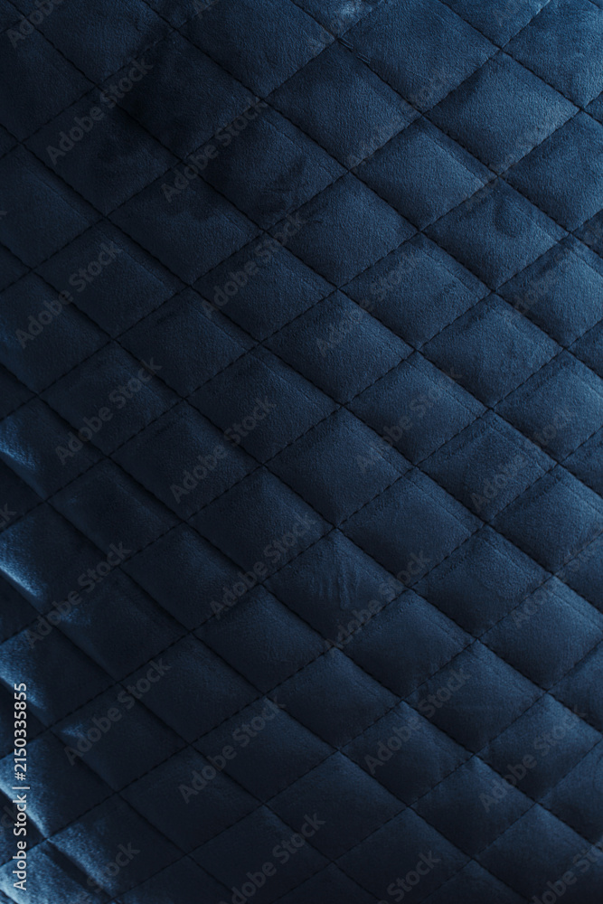 Obraz premium Moody Dark Blue Quilted Velvet Upholstery Texture with Diagonal Diamond Pattern
