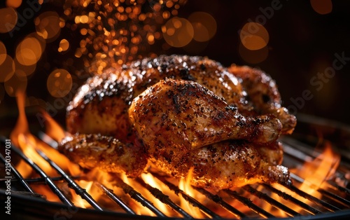 Whole Roasted Chicken Grilling Over Open Flames on a Barbecue.