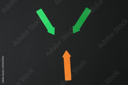 Paper arrow on color background, top view