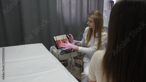 Trichologist examining hair structure and showing patient result