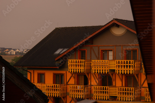Cuadro en lienzo slovak hotel building facade with yellow walls and wooden balconies sunset warm