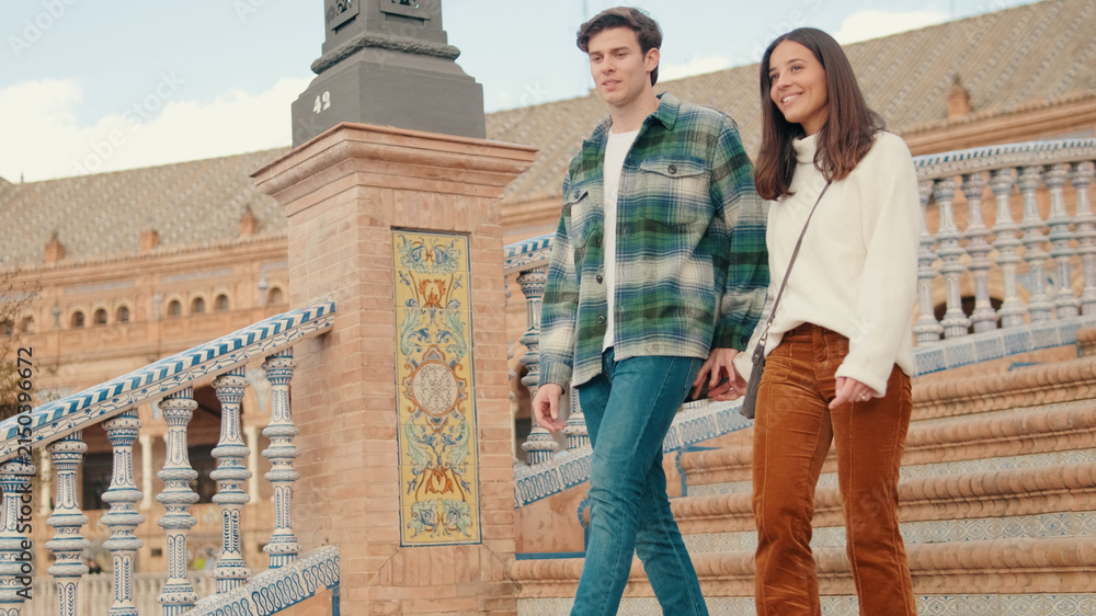 Fototapeta premium Couple Walking Up Colorful Tile Staircase