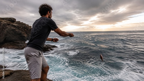 Handline fishing from rocks photographed in crisp daylight with clear form and commercial polish