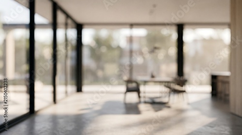 Blurred interior of a modern dining room with large windows and a view