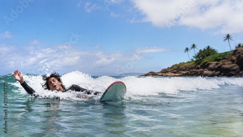 Surfer wiping out captured from a low angle with bold form and editorial character authentic refined