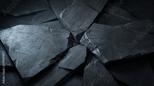 Abstract dark slate stone background with cracked tectonic plates grinding together in dramatic lighting