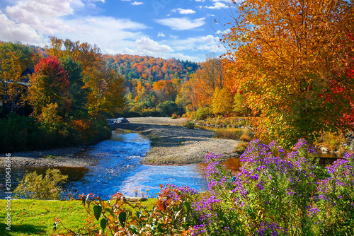 Beautiful autumn colors along a river in the countryside of Vermont, USA