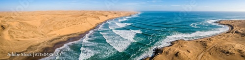 Aerial Panorama of Desert Sand Dunes Meeting Turquoise Ocean Coastline