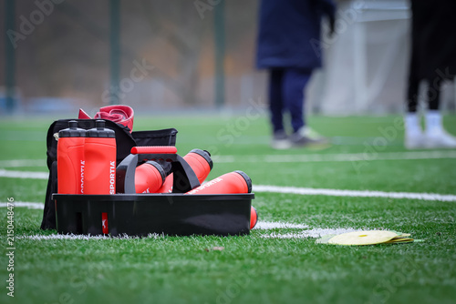 Sports Water Bottles and Training Equipment on Artificial Turf Field
