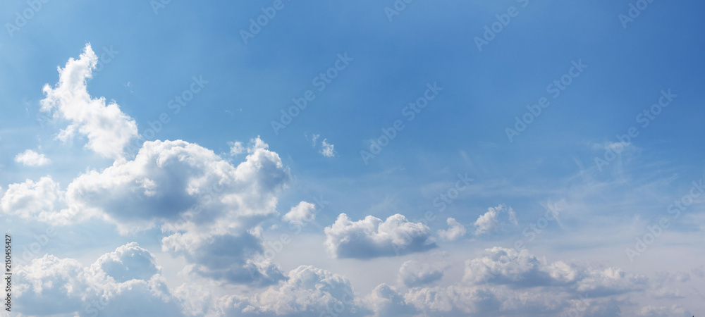 Fototapeta premium Panoramic blue sky with scattered fluffy white clouds below