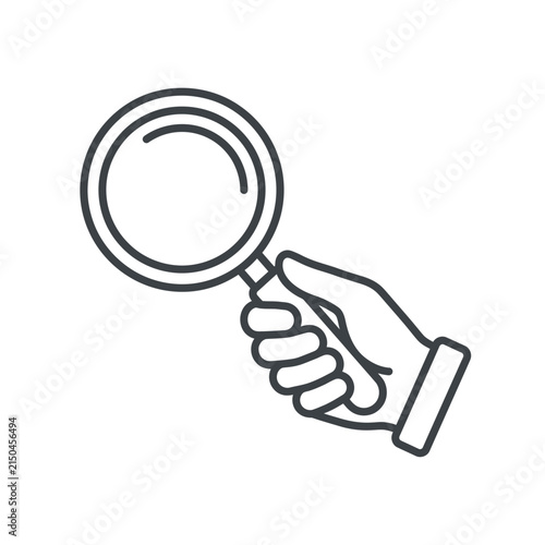 Hand holding a large magnifying glass for search