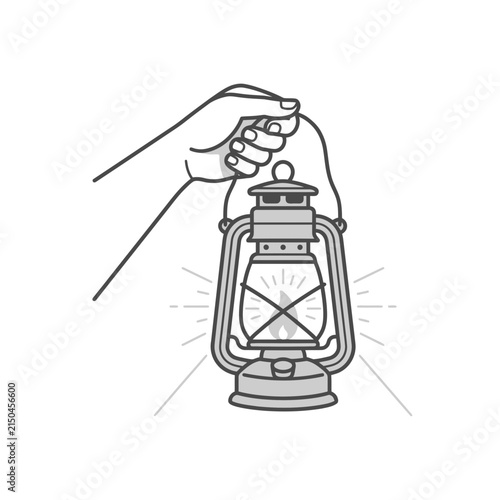 Hand holding a vintage oil lantern lamp lit.