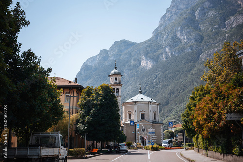 Small towns near Lake Garda in Italy show buildings and mountains during a sunny day