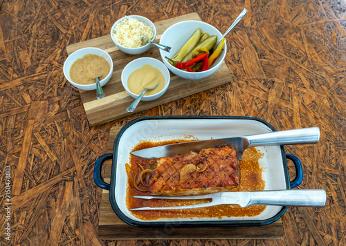 Roasted Pork Belly with Onions and horseradish, mustard and pickles on the side, Classic Czech Cuisine