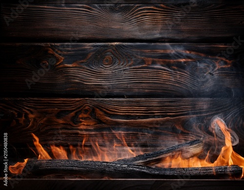 blackened wood texture with smoldering areas perfect for showcasing spicy and grilled food products with ample copy space