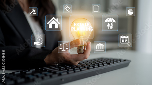 Cuadro en lienzo Business professional holding light bulb with digital icons, representing estate planning concepts and financial decisions, on keyboard in modern workspace