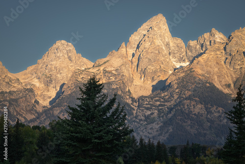 jagged mountain peaks of the Grand Tetons bathed in warm sunlight