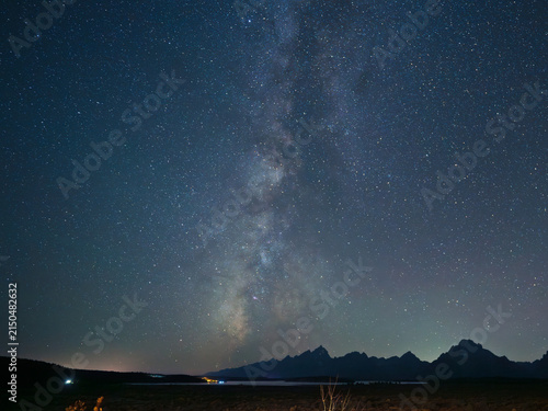 Breathtaking view of the Milky Way galaxy over a silhouetted the Grand Tetons at night