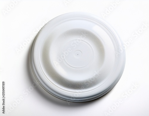 a white frisbee also known as a flying disc is shown from a high angle isolated on a white background ready for a game of catch