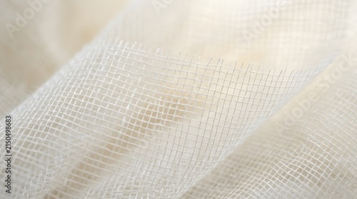 Delicate white gauze fabric with a distinct grid pattern captured in soft natural lighting creating gentle flowing wave organic folds