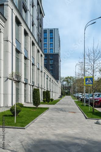 An alley with lawns along multi-story residential building