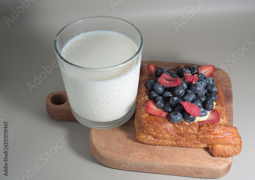 Quadro su tela Gourmet Mixed Berry Danish Pastry with Glass of Fresh Milk on a neutral backgrou