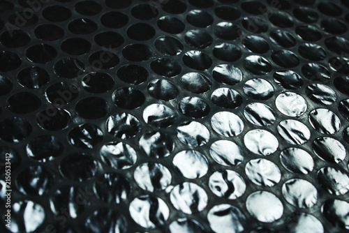 Black Bubble Wrap Plastic Texture Close Up With Circular Air Pocket Pattern Background