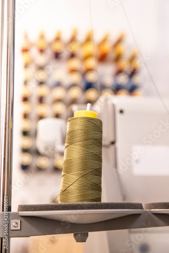 Photography A spool of sewing thread on a varied background, with space for text nearby
