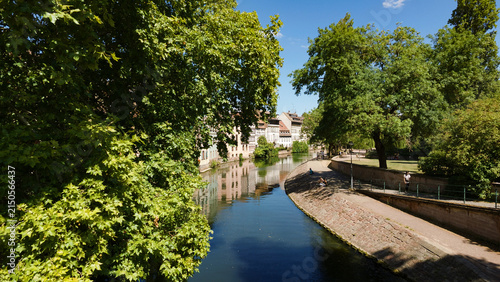 Strasbourg cityscape with buildings reflecting in the Ill River on a sunny day