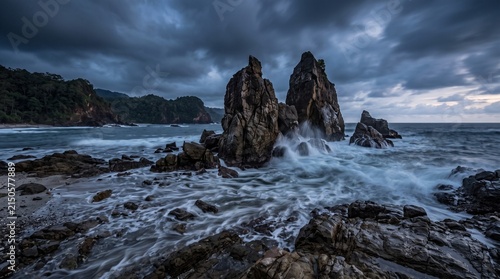 Dramatic rocky coastline at twilight with crashing ocean waves, nature photograp