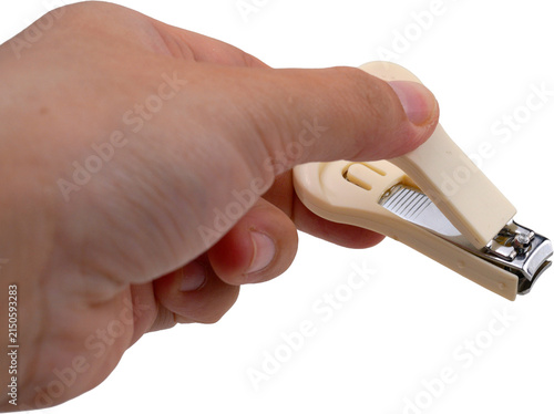 A hand holding a beige nail clipper against a transparent background.