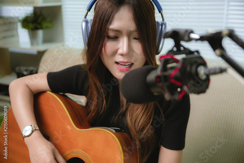 Photography Close up Asian female musician practicing acoustic guitar singing content creato