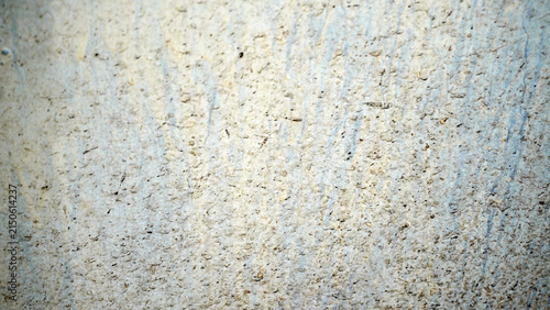 Rough sandy concrete surface texture with subtle streaks and grain.